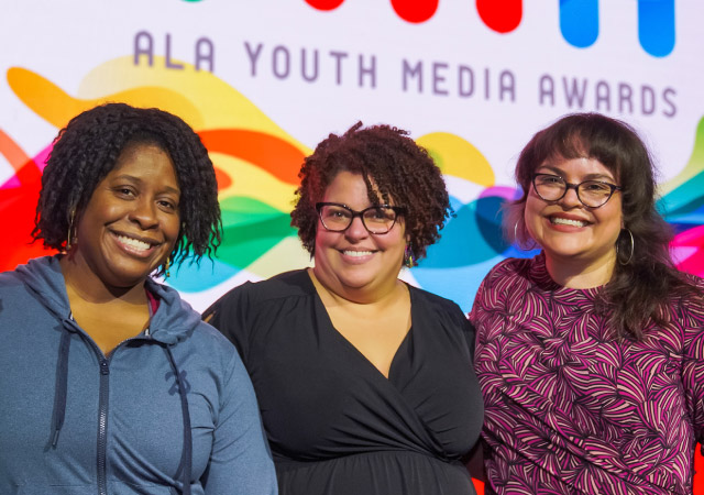 Photo of three women on the Youth Media Award stage for LibLearnX 2023